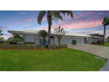 Attractive condo exterior featuring a landscaped lawn and two-car garage at 6810 9Th W Ave, Bradenton, FL 34209
