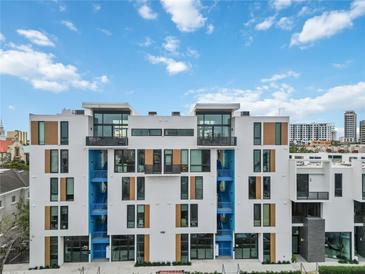 Modern building with blue accents and wood details at 1558 4Th St # 402, Sarasota, FL 34236
