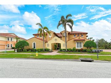 Luxury Mediterranean home with tile roof, three-car garage, and lush landscaping at 206 Bella Vista Ter # 29B, North Venice, FL 34275