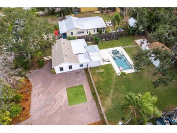 Aerial view showing home, pool, and large paved driveway at 2826 Marlette St, Sarasota, FL 34231