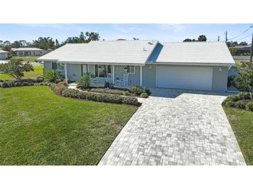 Updated single-story home with a large driveway and landscaped lawn at 308 Matisse E Cir, Nokomis, FL 34275