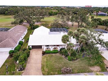 White-roofed house with pool and lush landscaping, offering a desirable location at 3746 Torrey Pines Blvd, Sarasota, FL 34238