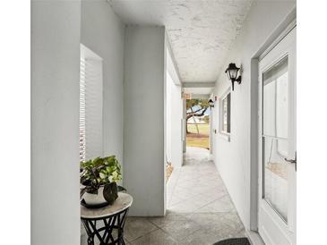 Bright hallway with tiled floors and access to outdoor patio at 404 Cerromar N Cir # 108, Venice, FL 34293