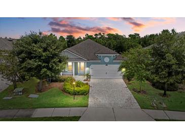 One-story home with a white garage door and landscaped yard at 5307 Applegate Ct, Bradenton, FL 34211