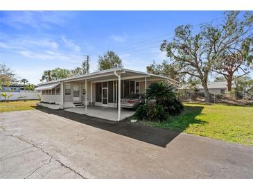 Charming single-story home featuring a covered carport and well-maintained landscaping in a quiet neighborhood at 703 Corsica Ct, Bradenton, FL 34207