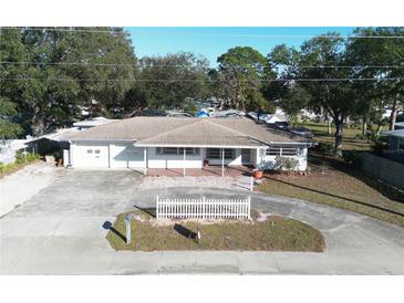 Aerial view of a single-Gathering home with a large front yard and driveway at 975 S Tuttle Ave, Sarasota, FL 34237