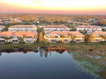 Aerial view of a lakefront property with multiple villas at 1274 Burgos Dr # 1101, Sarasota, FL 34238