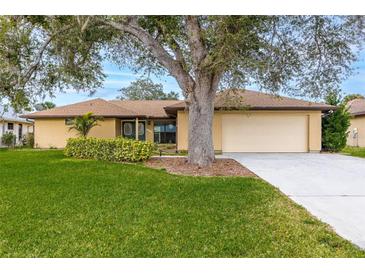 Single-story home with attached garage and lush lawn at 1313 Harbor Blvd, Port Charlotte, FL 33952