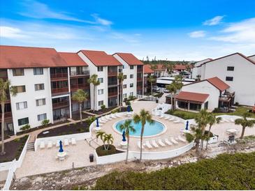 Aerial view of condo complex with pool and surrounding landscape at 1604 Stickney Point Rd # 102, Sarasota, FL 34231