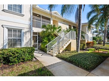 Well-maintained condo building with lush landscaping and inviting entryway at 200 Mirabella Cir # 201, Venice, FL 34292