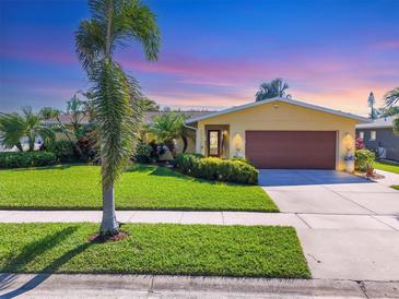 Beautiful ranch home with a well-manicured lawn and updated facade at 2424 Post Rd, Sarasota, FL 34231