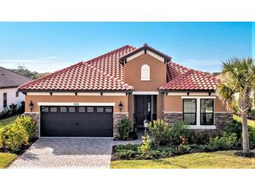 Attractive single-story home with tile roof and stone accents at 26858 Weiskopf Dr, Englewood, FL 34223