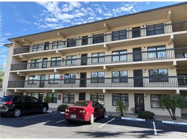 Three-story condo building with parking and balconies at 625 30Th W Ave # G409, Bradenton, FL 34205