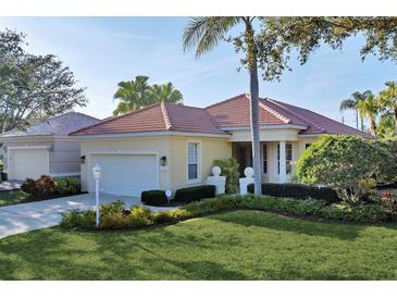 Single-story home with attached garage and well-manicured lawn at 7220 Kensington Ct, University Park, FL 34201