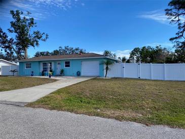 Charming light blue single-story home with a white fence and driveway at 881 Polaris Rd, Venice, FL 34293