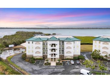 Aerial view of waterfront community with tennis courts and pool at 9203 Griggs Rd # D103, Englewood, FL 34224