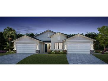 Two-story house with a two-car garage and landscaped yard at 18725 Dayspring Pl, Venice, FL 34293