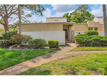 Attractive condo entrance with landscaping and walkway at 2421 Crispin Ct # E3, Sarasota, FL 34235