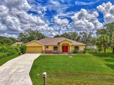 House exterior with a large front yard and driveway at 2534 Stagnaro Rd, North Port, FL 34287