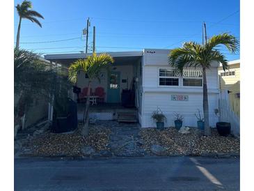 Quaint waterfront home with palm trees and a relaxing patio area at 2601 Gulf N Dr # 729, Bradenton Beach, FL 34217