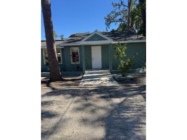 Charming green house with a landscaped yard and walkway at 506 Houle Ave, Sarasota, FL 34232