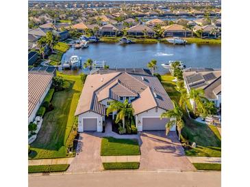 Luxury waterfront home with private dock and two-car garage; beautiful landscaping at 5607 Tidewater Preserve Blvd, Bradenton, FL 34208