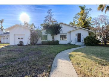 White single-story house with attached garage and landscaped yard at 116 23Rd W St, Bradenton, FL 34205