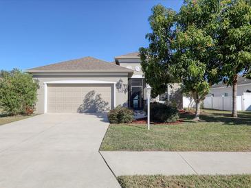 Tan house with a two-car garage and landscaped yard at 2824 47Th E St, Palmetto, FL 34221