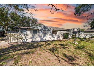 Gray house with a fenced yard and landscaping at 2925 29Th W Ave, Bradenton, FL 34205