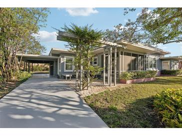 Mid-century modern home with carport and screened porch at 349 Scott Ave, Sarasota, FL 34243