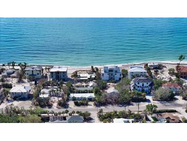 Aerial view of beachfront homes and properties showcasing oceanfront living at 6501 Gulf Of Mexico Dr, Longboat Key, FL 34228
