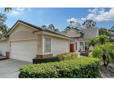 Two-car garage, attractive landscaping, and a charming front entrance at 7741 Whitebridge Gln, University Park, FL 34201