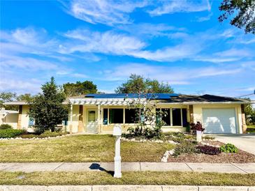 Updated single-story home with solar panels and a landscaped yard at 1414 6Th W St, Palmetto, FL 34221