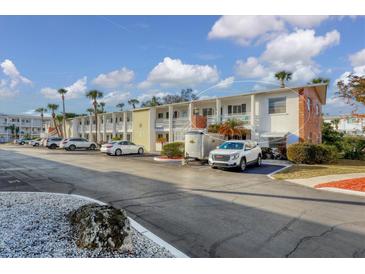 Condo building with parking and surrounding landscape at 1553 Pleasant Rd # H27, Bradenton, FL 34207