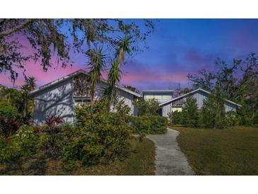 Two-story house with landscaped yard, stone accents, and a walkway at 3651 Country Place Blvd, Sarasota, FL 34233