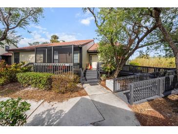 Inviting exterior of a single story home with a screened porch and walkway at 4351 Trails Dr # 4-2, Sarasota, FL 34232