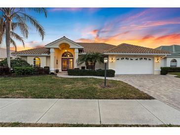 Attractive single-story home with a landscaped yard and two-car garage at 5061 Seagrass Dr, Venice, FL 34293