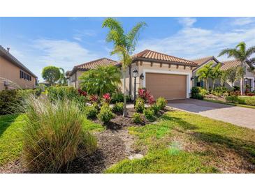 Single-story home with a landscaped yard and attached garage at 5337 Popoli Way, Sarasota, FL 34238