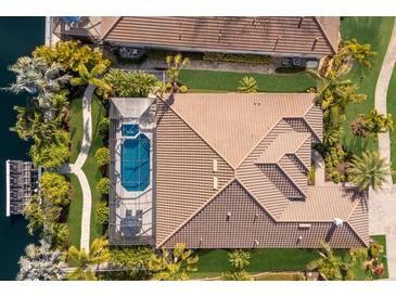 Aerial view of a luxury home with pool and canal access at 579 Fore Dr, Bradenton, FL 34208