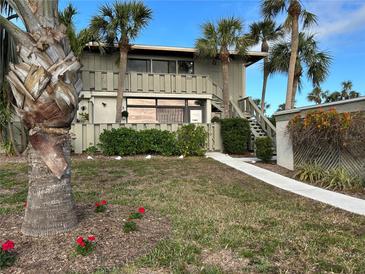 Charming two-story condo with well-maintained landscaping and inviting stairway entrance at 6200 Flotilla Dr # 261, Holmes Beach, FL 34217