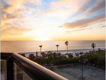 Breathtaking sunset over the ocean, beach, and tennis courts at 1281 Gulf Of Mexico Dr # 404, Longboat Key, FL 34228