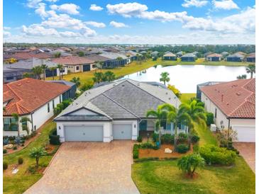 Luxury home with lake view in a gated community with tile roof at 17722 Littleton Pl, Lakewood Ranch, FL 34202