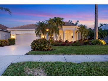 Beautiful home with landscaping, a large driveway, and a two-car garage at 2037 Silver Palm Rd, North Port, FL 34288