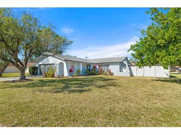 White house with gray roof, nicely landscaped yard, and a spacious driveway at 2302 15Th W St, Palmetto, FL 34221