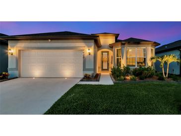 Beautiful home exterior with landscaping and lighting at 2930 61St E Dr, Ellenton, FL 34222