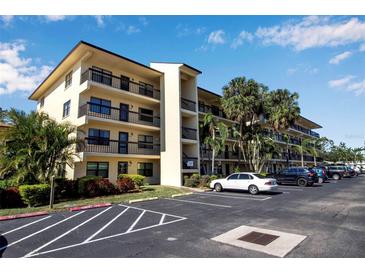 Exterior view of a two-story condominium building with ample parking at 315 30Th W Ave # B210, Bradenton, FL 34205