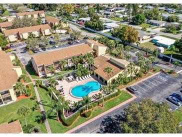 Aerial view of a condo community featuring a swimming pool and ample parking at 3471 Clark Rd # 269, Sarasota, FL 34231