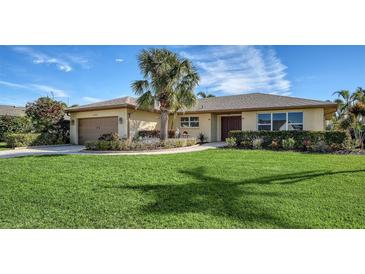 Single-story home with a landscaped lawn, attached garage, and attractive curb appeal at 4503 Coral Lake Dr, Bradenton, FL 34210
