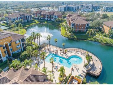 Aerial view of community pool, lake, and resort-style amenities at 8335 38Th Street E Cir # 303, Sarasota, FL 34243