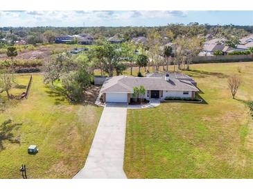 Well maintained single Gathering home features mature trees and a long driveway at 1573 Shadow Ridge Cir, Sarasota, FL 34240